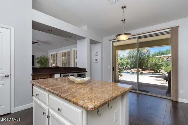a bathroom with a granite countertop sink and a large mirror