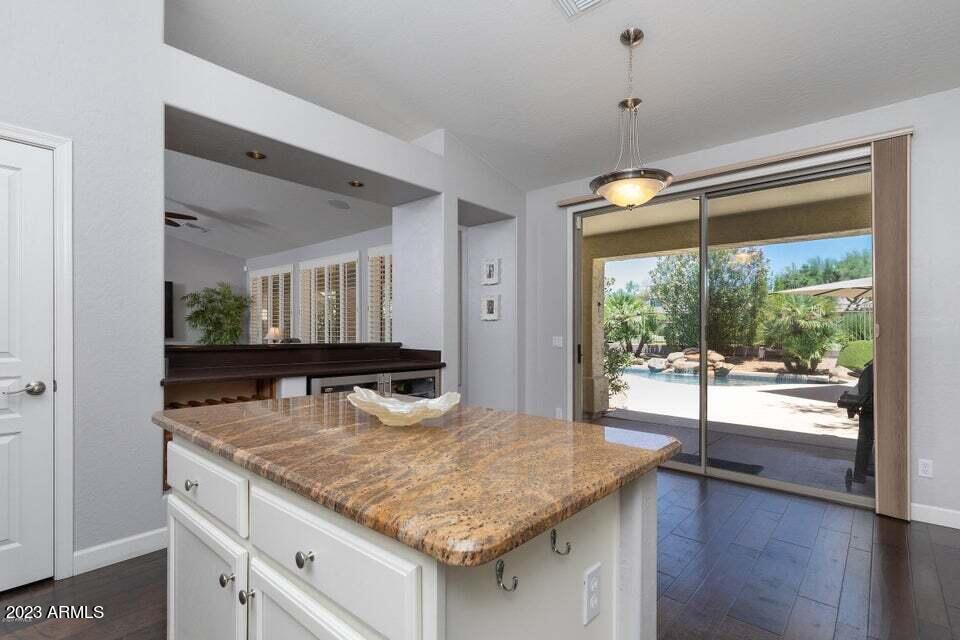 7338 East Wingspan Way Scottsdale, AZ 85255 - Photo 13 of 32 a bathroom with a granite countertop sink and a large mirror