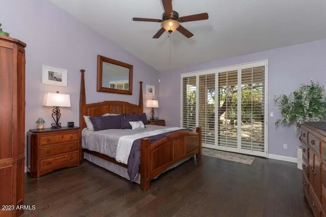 a bedroom with a bed lamp and a large window