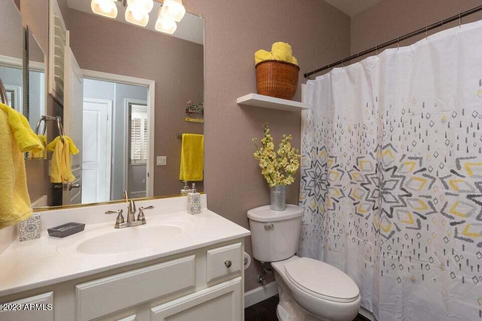 7338 East Wingspan Way Scottsdale, AZ 85255 - Photo 20 of 32 a bathroom with a toilet sink and mirror