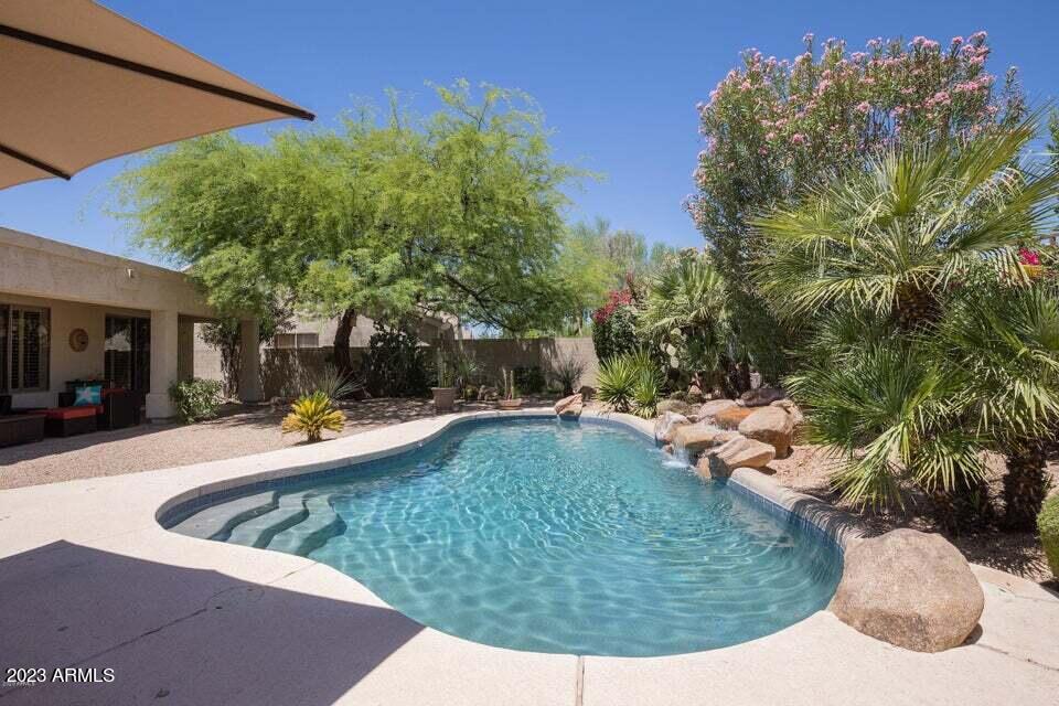 7338 East Wingspan Way Scottsdale, AZ 85255 - Photo 28 of 32 a view of a swimming pool with a patio