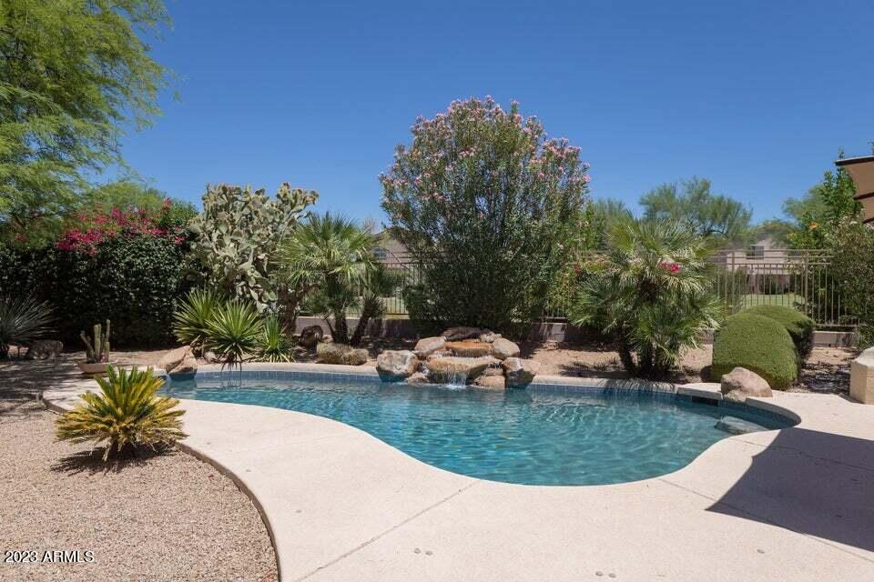 7338 East Wingspan Way Scottsdale, AZ 85255 - Photo 30 of 32 a view of a swimming pool with a sitting space
