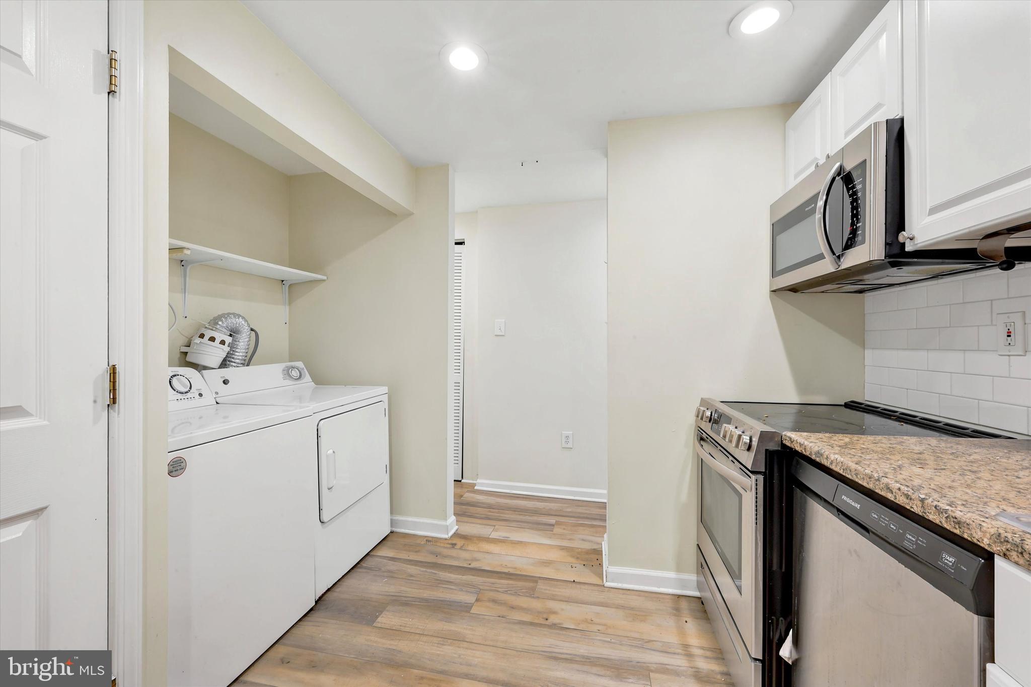 33 South 19th Street Philadelphia, PA 19103 - Photo 11 of 15 a utility room with cabinets washer and dryer