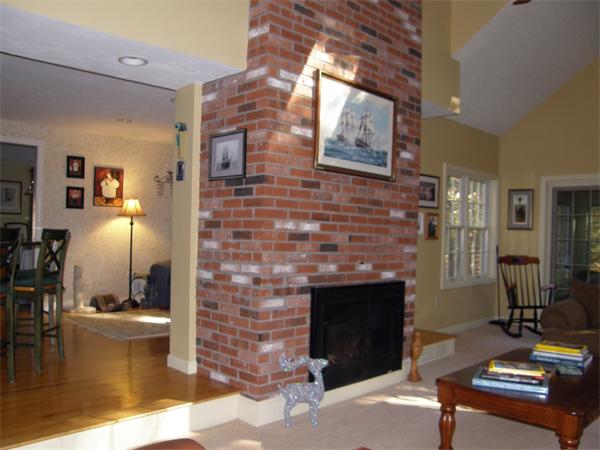 7 Callery Lane Canton, MA 02021 - Photo 8 of 10 a living room with furniture a flat screen tv and a fireplace