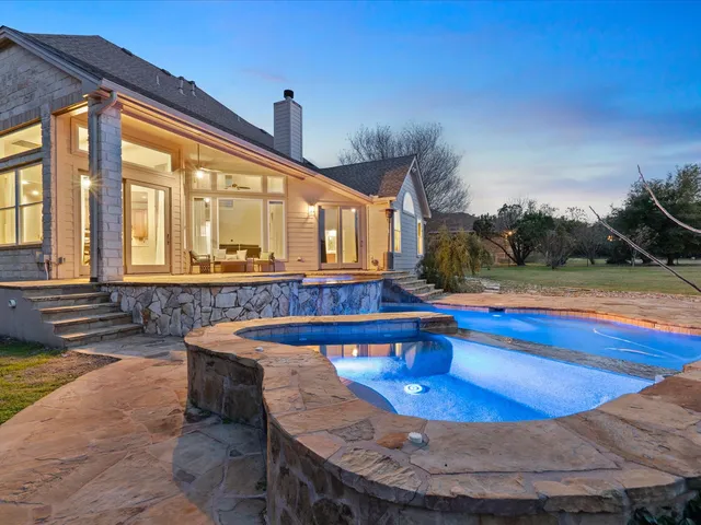 a view of a swimming pool with an outdoor seating