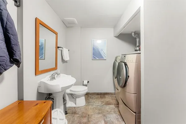 a bathroom with a toilet sink and mirror