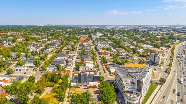 an aerial view of residential houses with outdoor space and trees