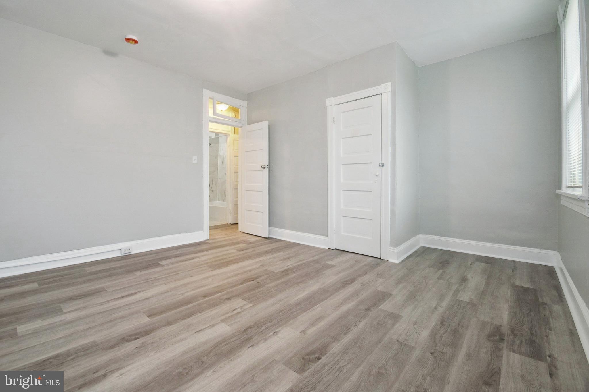 3020 Mathews Street Baltimore, MD 21218 - Photo 16 of 25 a view of an empty room with wooden floor and window