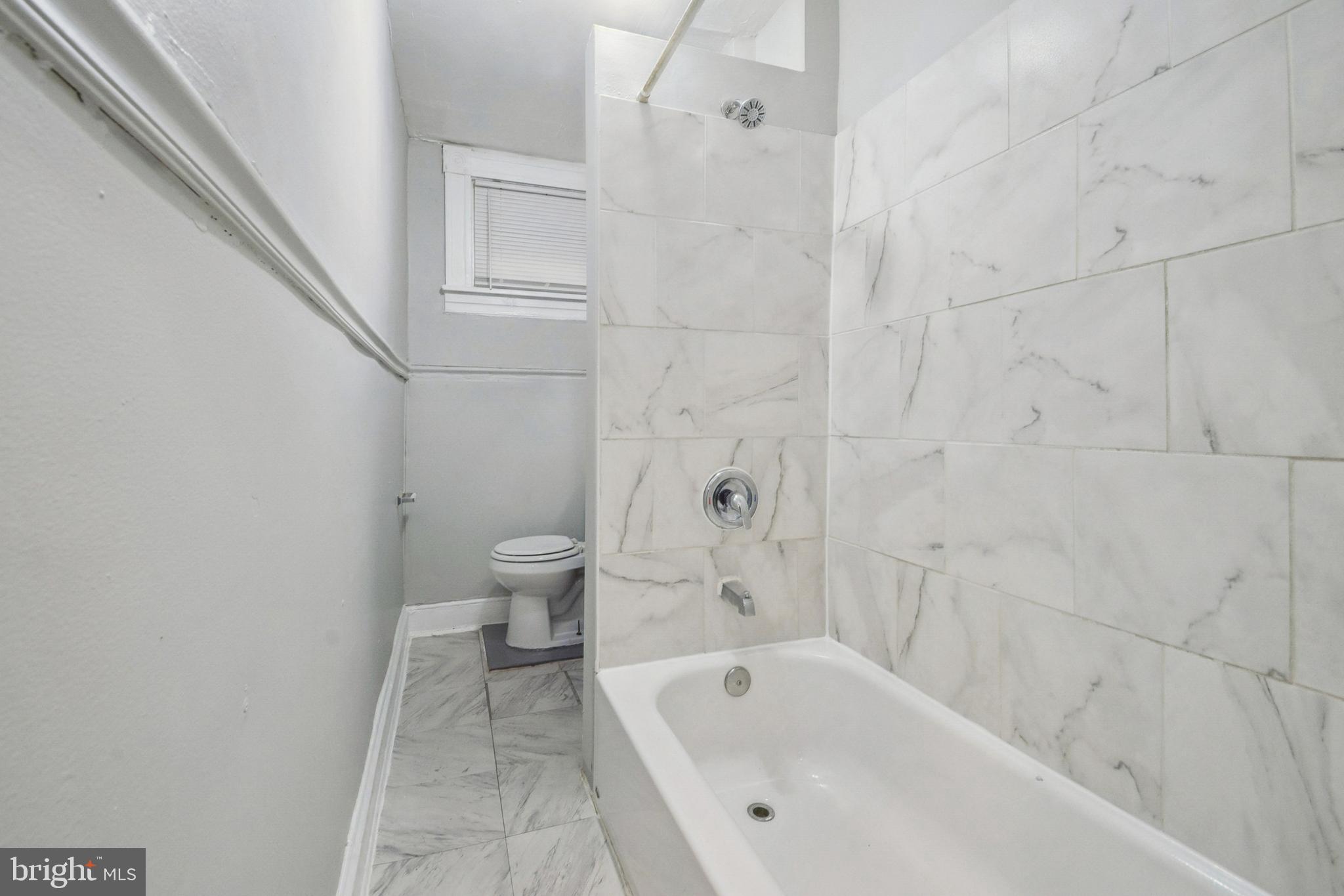 3020 Mathews Street Baltimore, MD 21218 - Photo 17 of 25 a bathroom with a bathtub and toilet