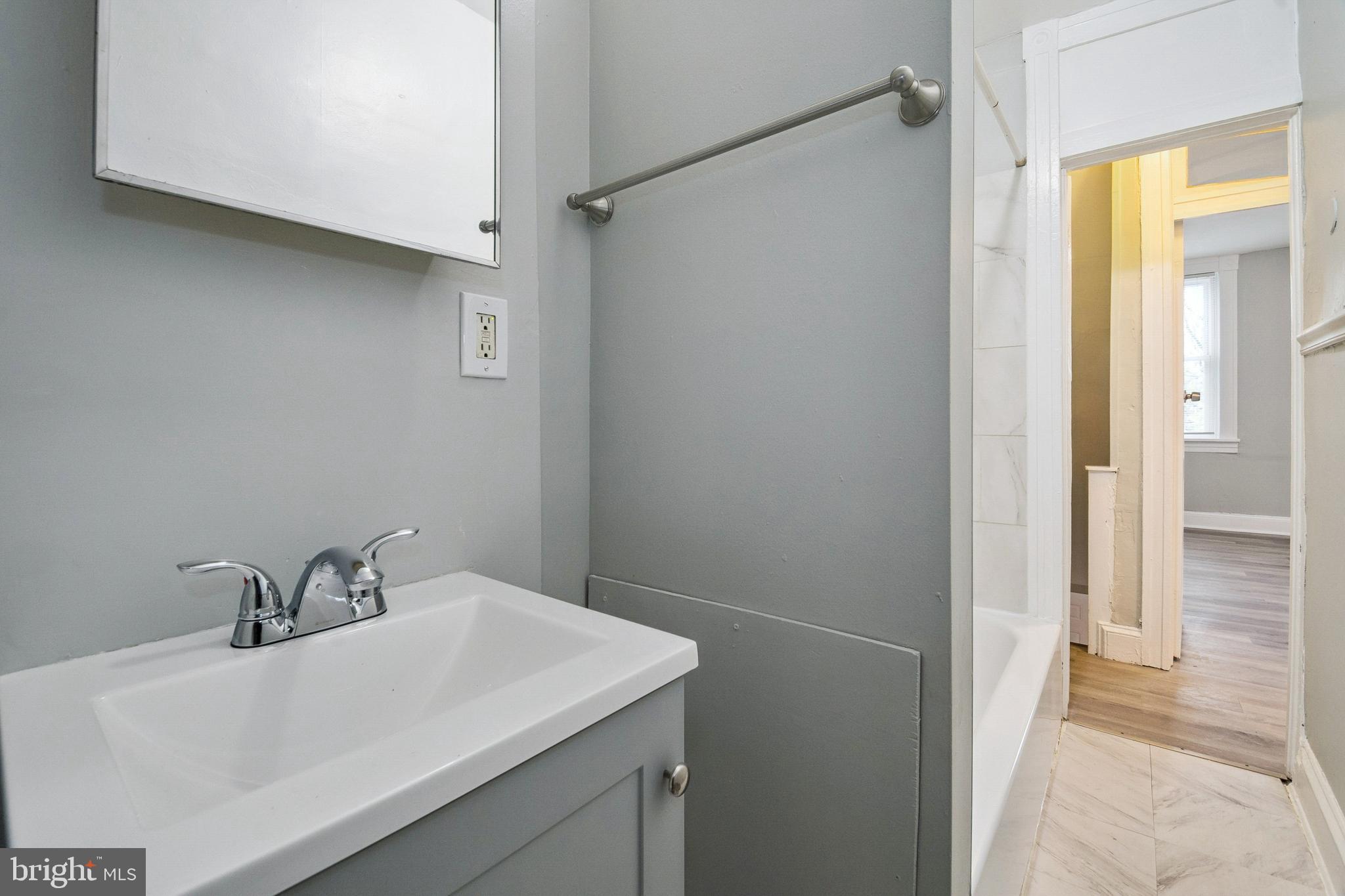 3020 Mathews Street Baltimore, MD 21218 - Photo 18 of 25 a bathroom with a sink and a mirror