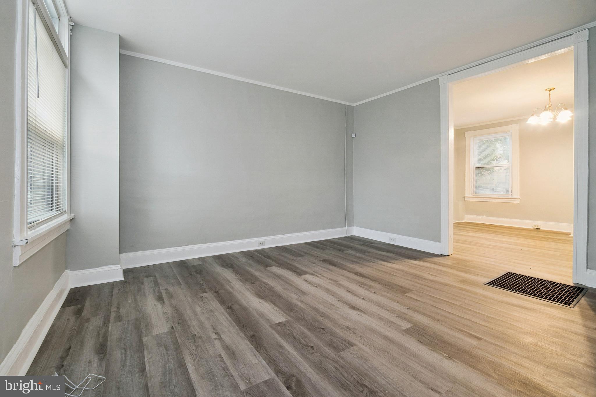 3020 Mathews Street Baltimore, MD 21218 - Photo 3 of 25 wooden floor in an empty room with a window