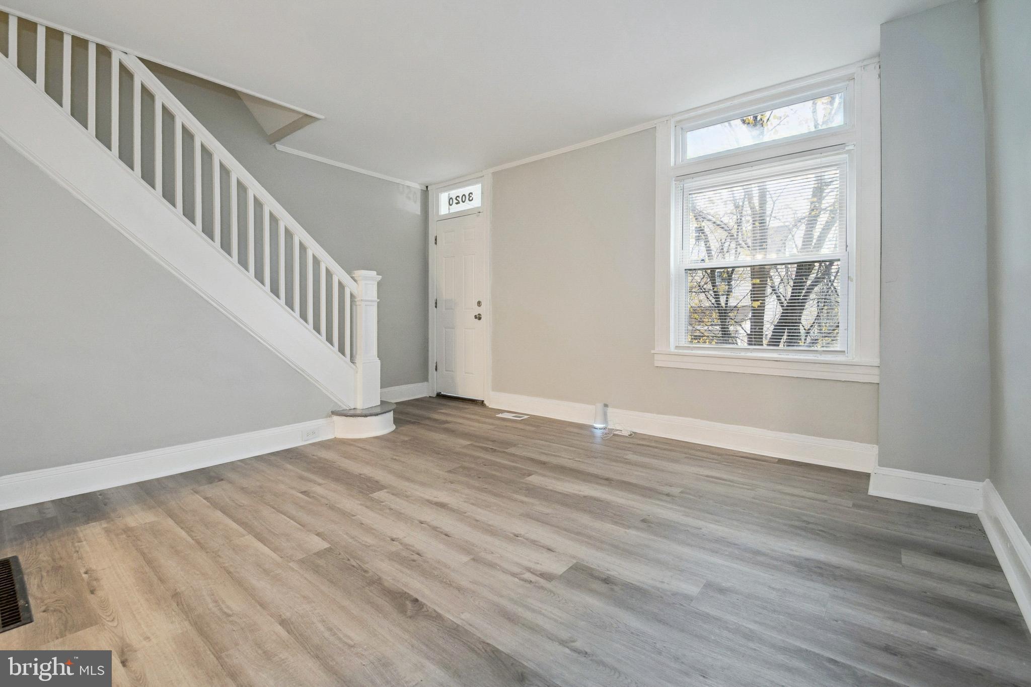 3020 Mathews Street Baltimore, MD 21218 - Photo 5 of 25 a view of an empty room with wooden floor and a window