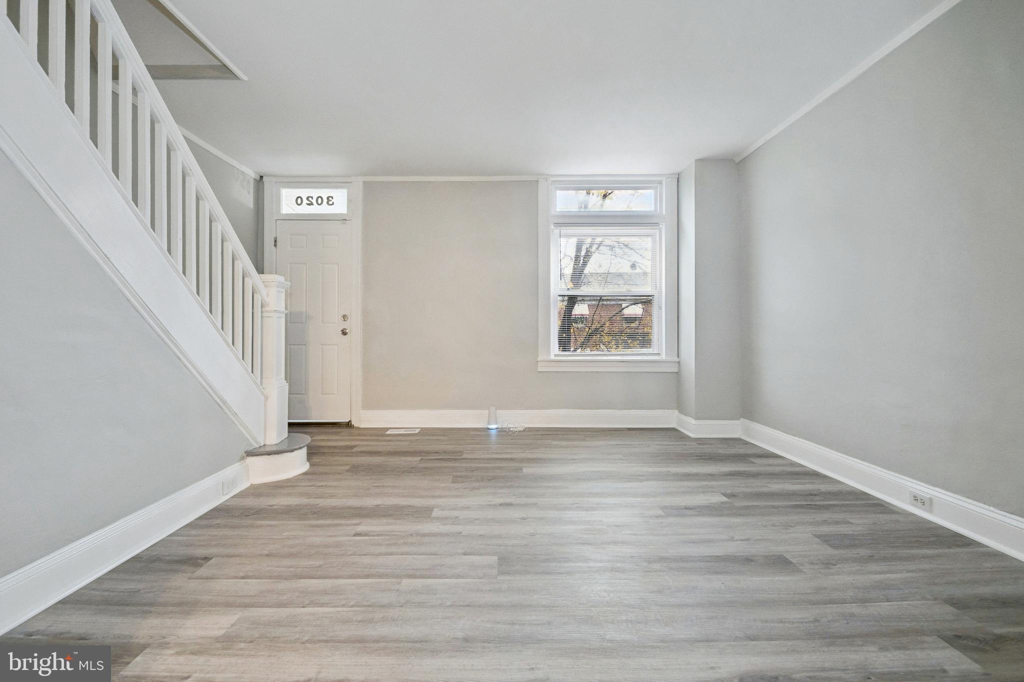 3020 Mathews Street Baltimore, MD 21218 - Photo 6 of 25 a view of an empty room with wooden floor and a window