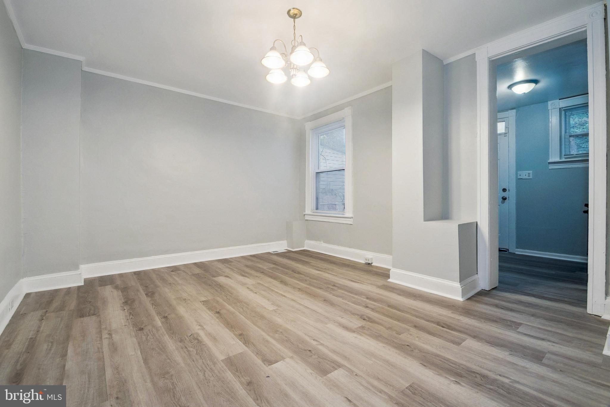 3020 Mathews Street Baltimore, MD 21218 - Photo 7 of 25 wooden floor in an empty room with a window