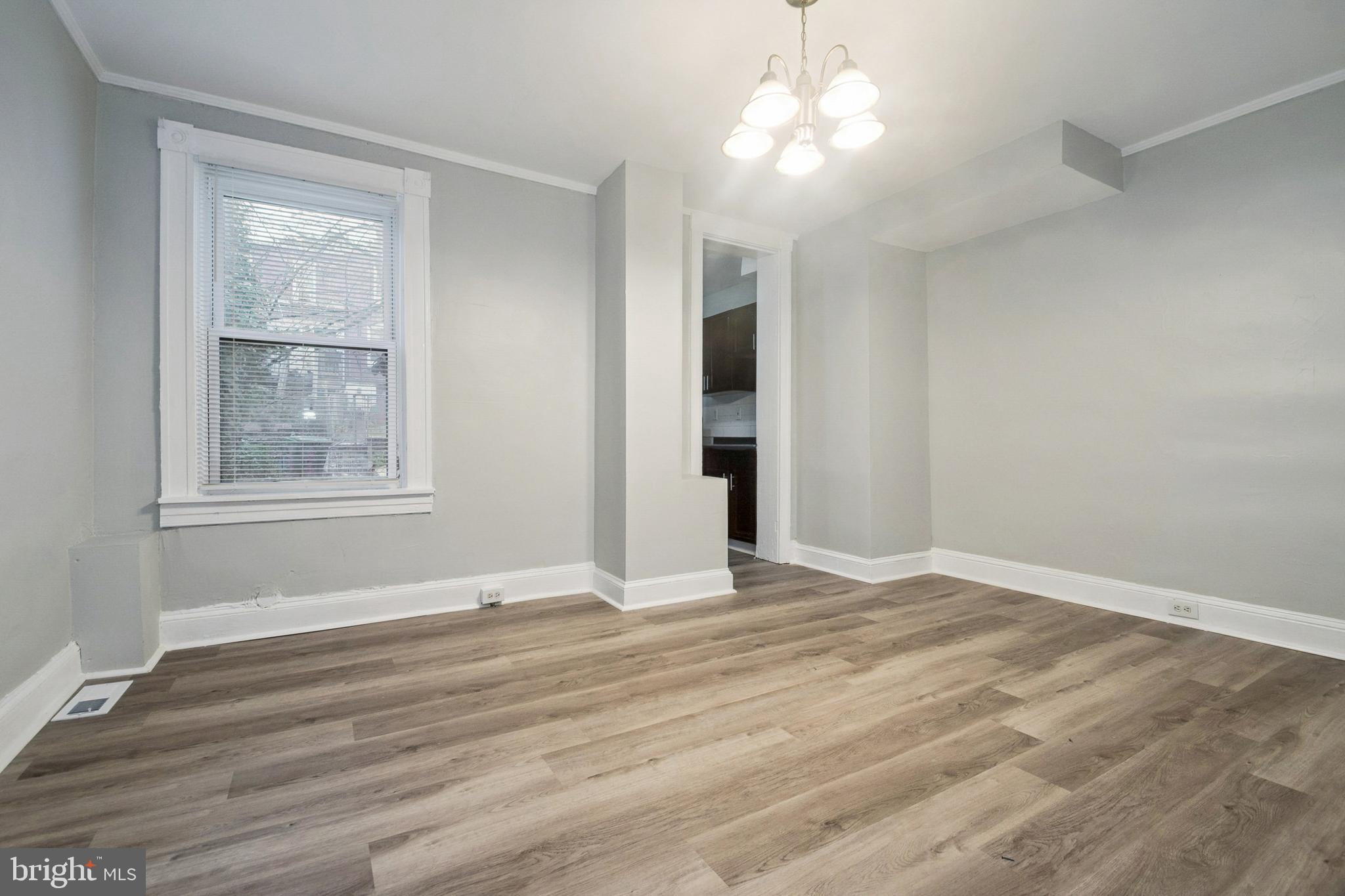 3020 Mathews Street Baltimore, MD 21218 - Photo 8 of 25 a view of an empty room with wooden floor and a window