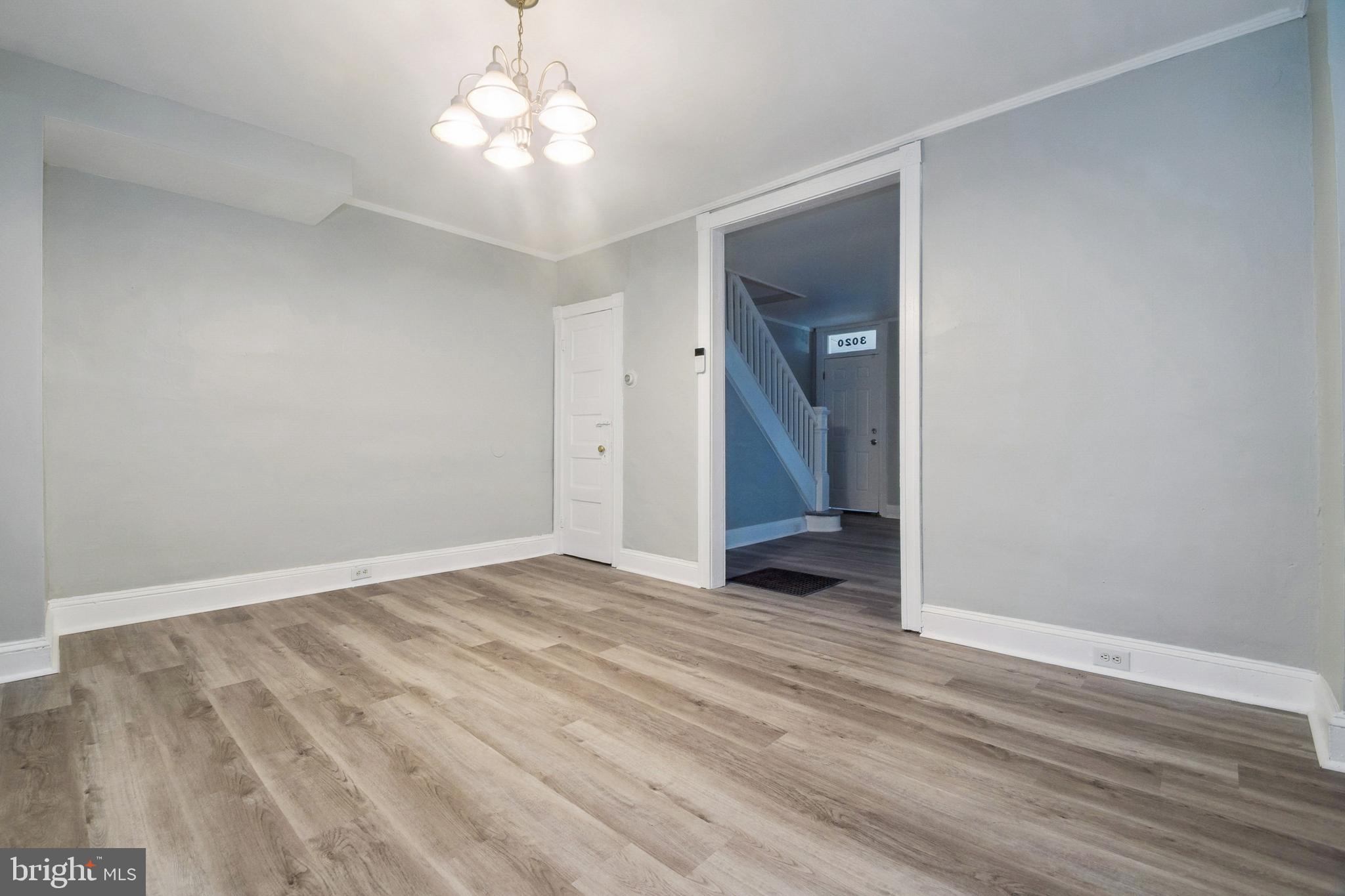 3020 Mathews Street Baltimore, MD 21218 - Photo 10 of 25 a view of an empty room with wooden floor and a window