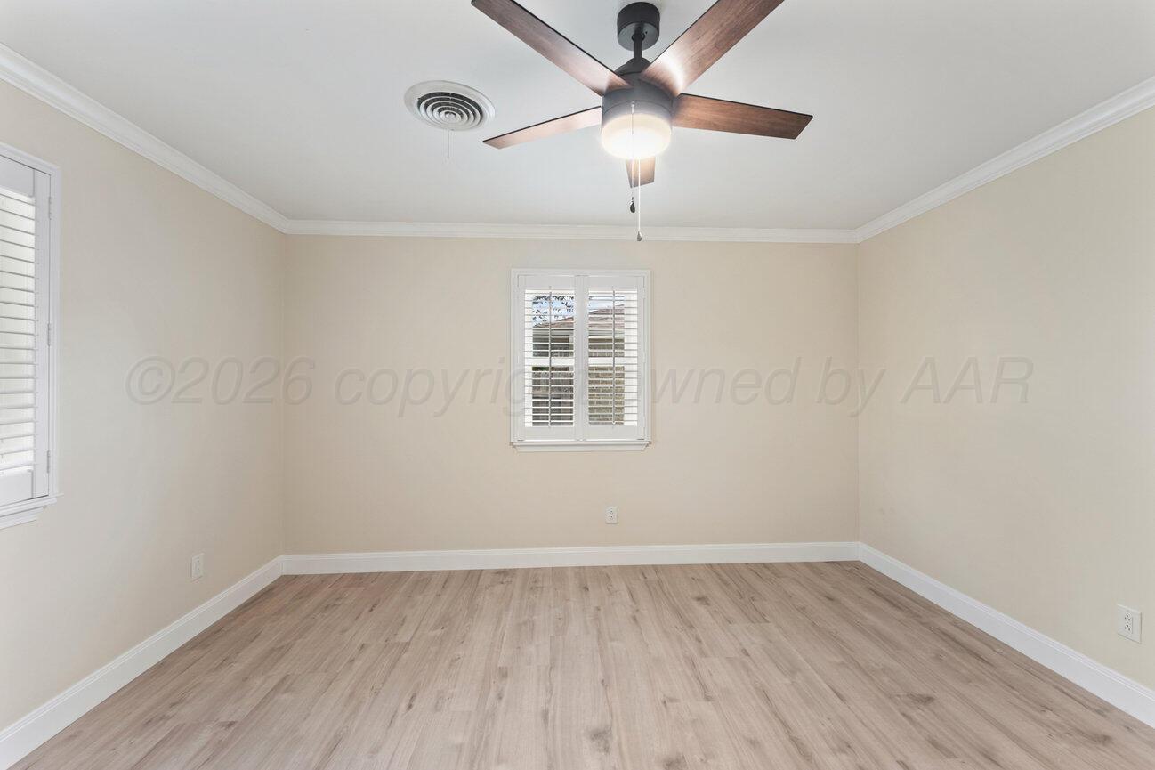7204 Southwest 39th Avenue Amarillo, TX 79109 - Photo 39 of 51 an empty room with wooden floor ceiling fan and window