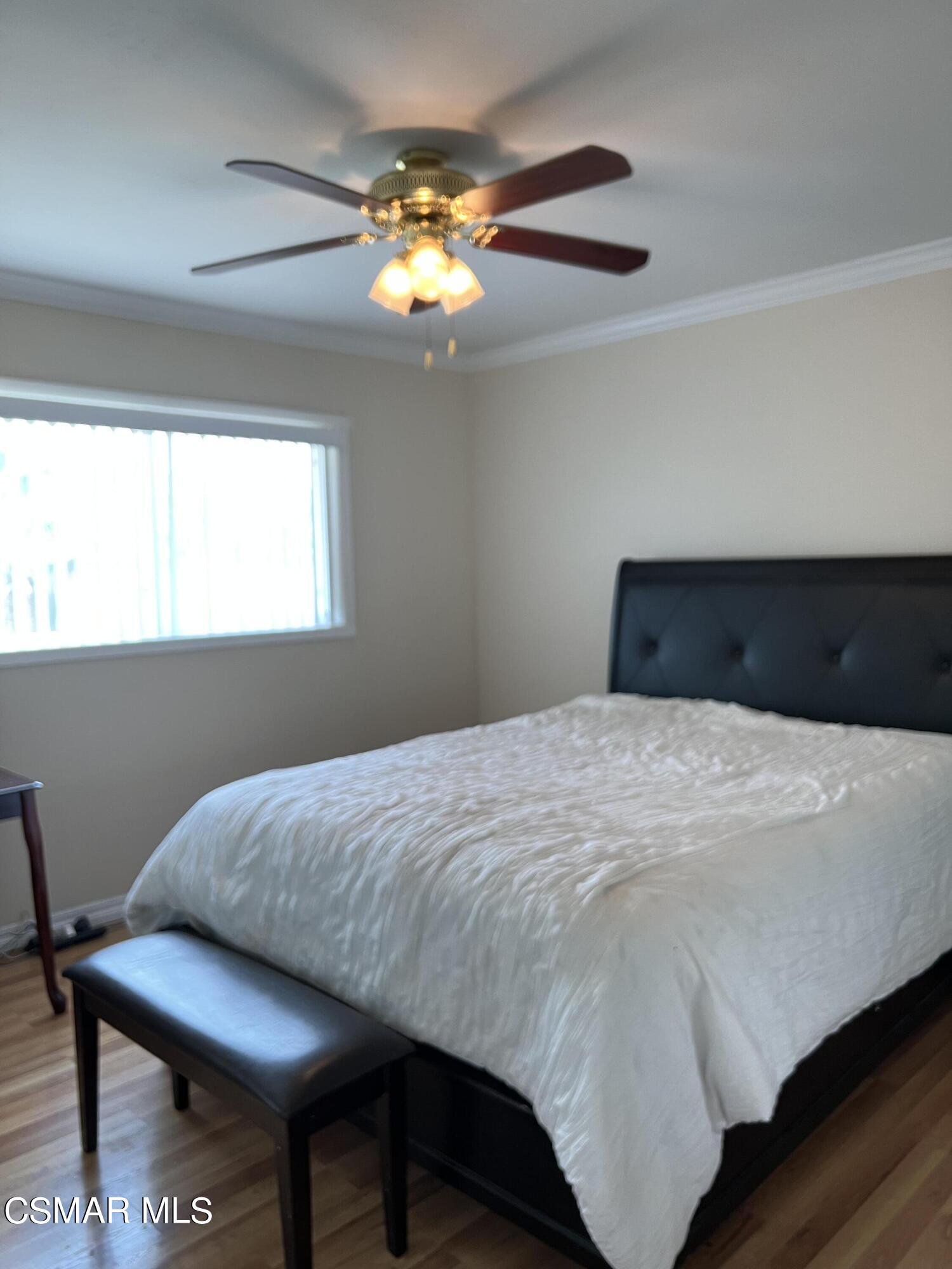 3546 Royal Avenue Simi Valley, CA 93063 - Photo 12 of 26 a bedroom with a bed and a chandelier