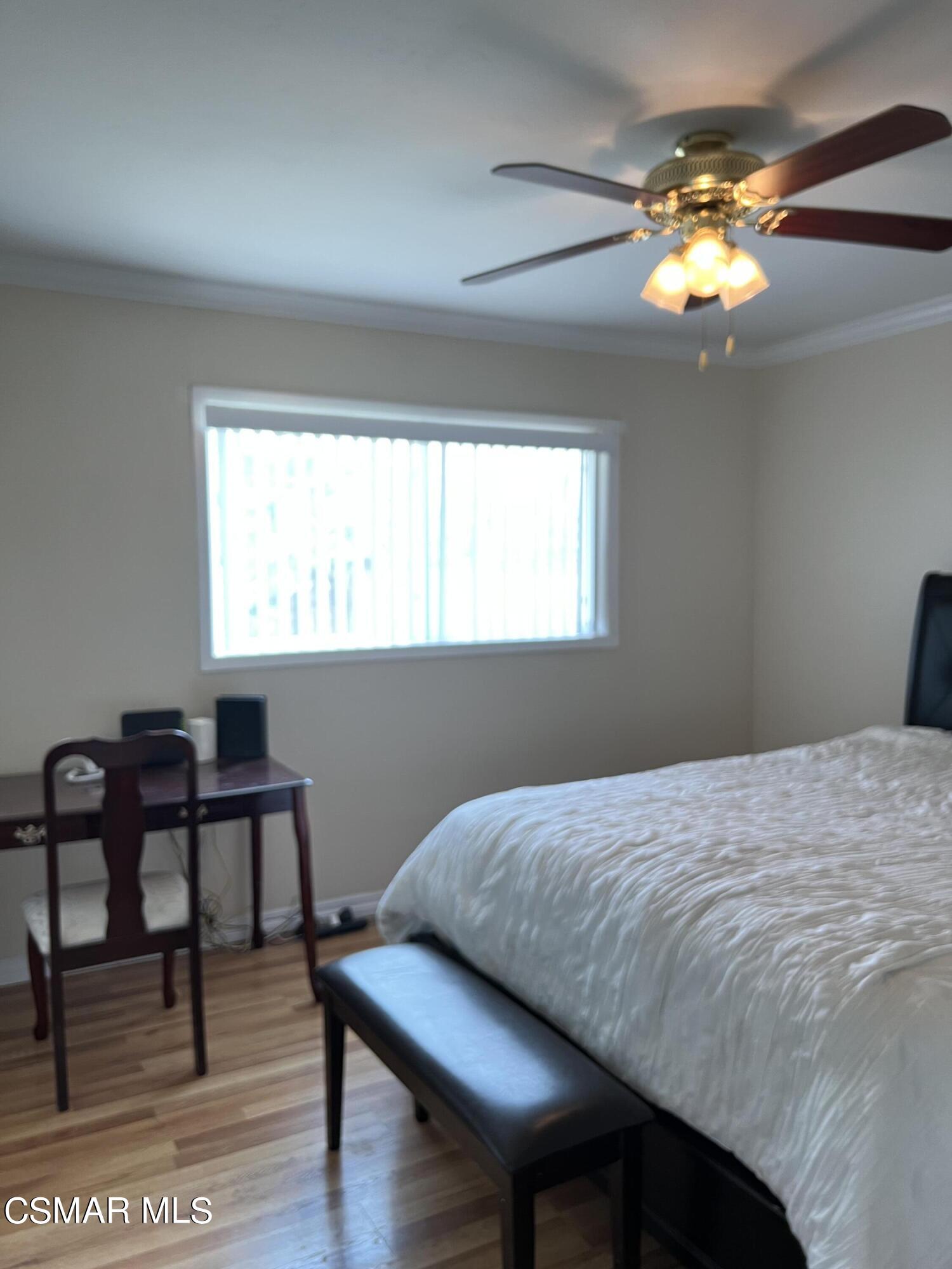 3546 Royal Avenue Simi Valley, CA 93063 - Photo 13 of 26 a bedroom with a bed and a chandelier