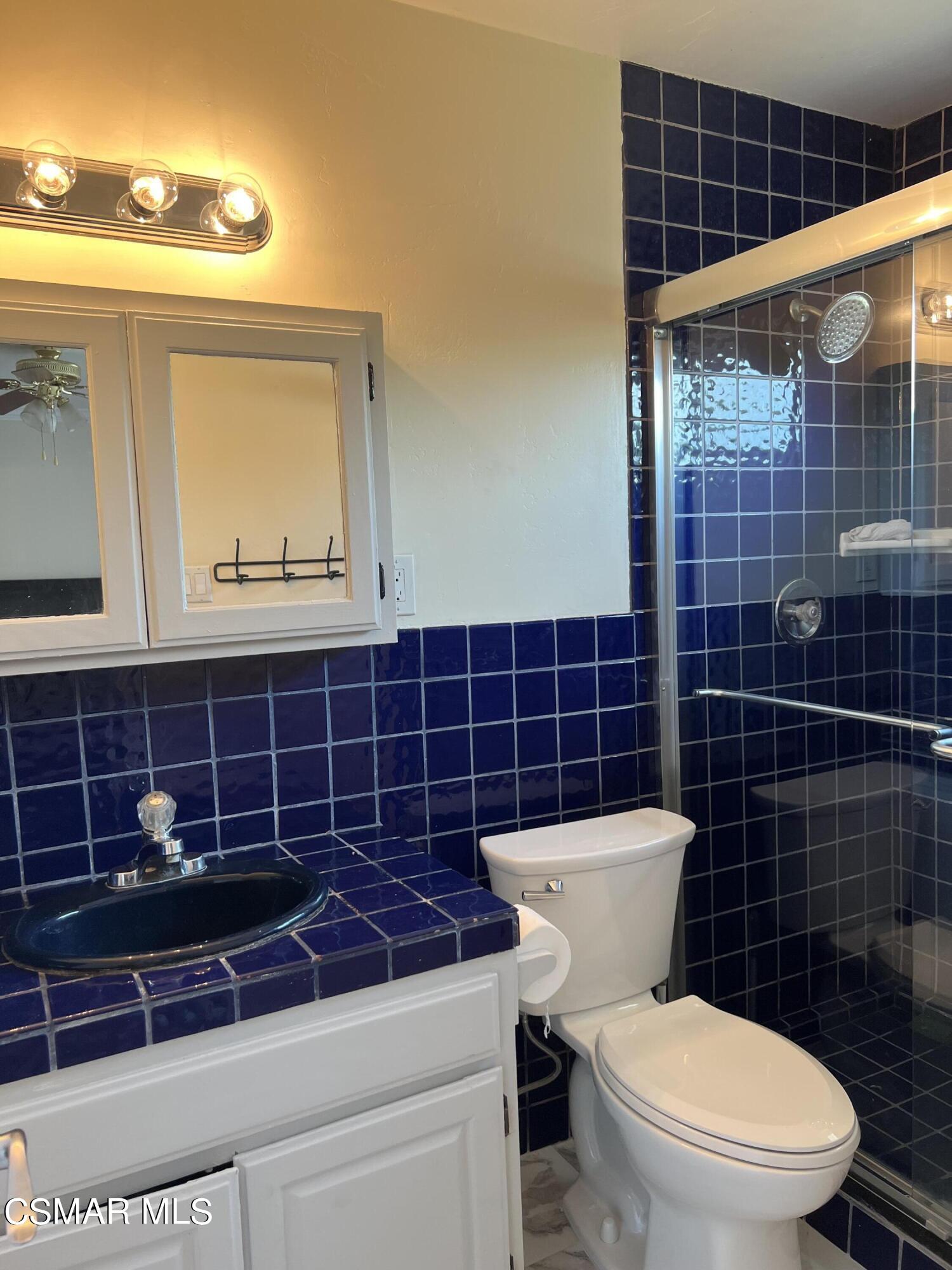 3546 Royal Avenue Simi Valley, CA 93063 - Photo 14 of 26 a bathroom with a toilet a sink and a shower