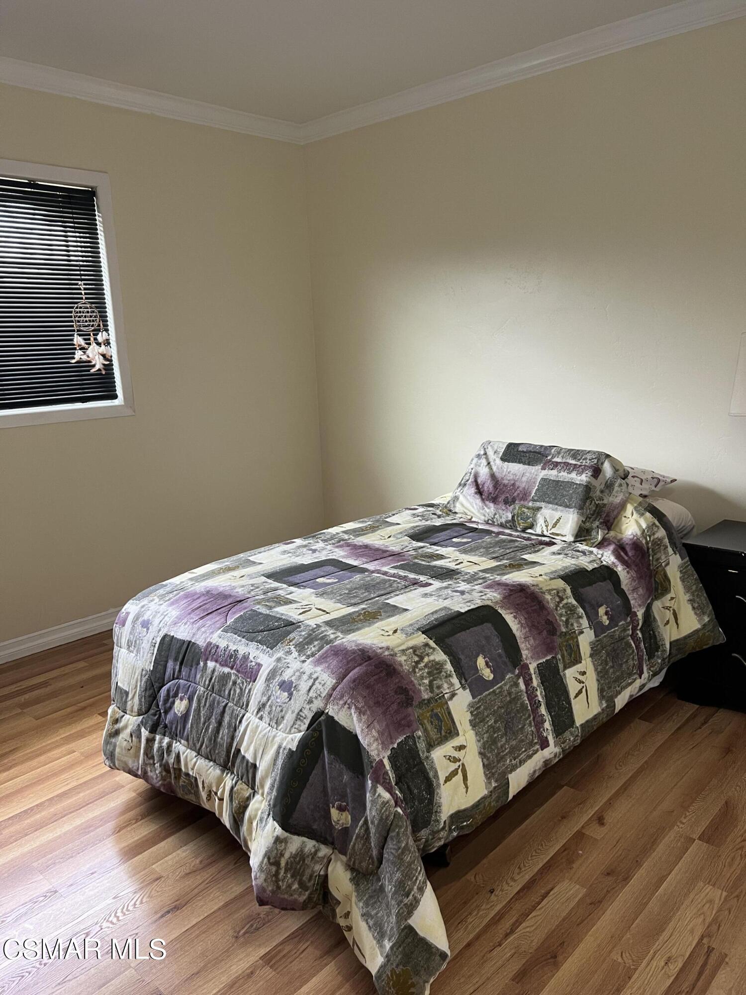 3546 Royal Avenue Simi Valley, CA 93063 - Photo 15 of 26 a bedroom with a bed with wooden floor