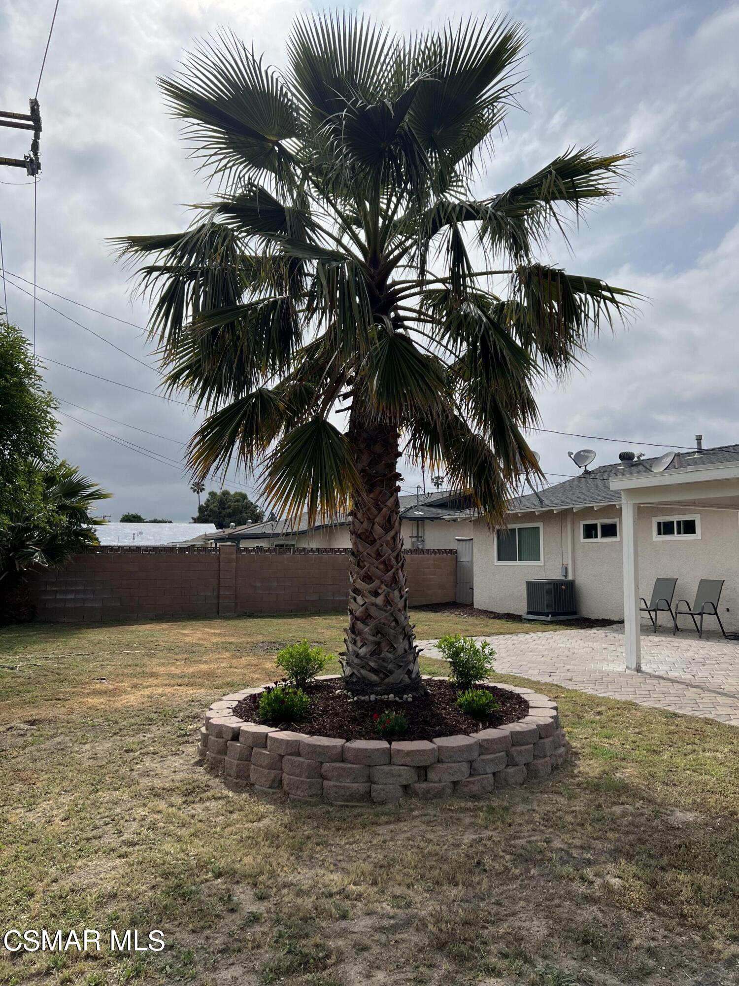 3546 Royal Avenue Simi Valley, CA 93063 - Photo 22 of 26 a view of a house with a yard and potted plants