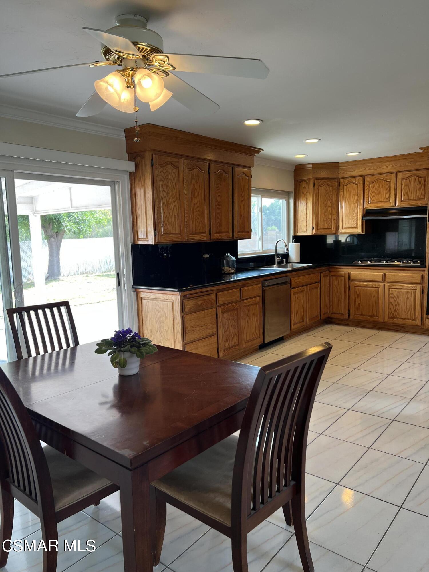 3546 Royal Avenue Simi Valley, CA 93063 - Photo 5 of 26 a kitchen with a dining table chairs and microwave
