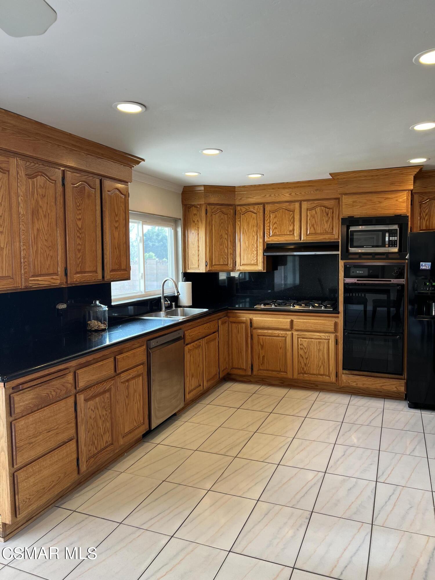 3546 Royal Avenue Simi Valley, CA 93063 - Photo 6 of 26 a kitchen with stainless steel appliances a sink cabinets and window
