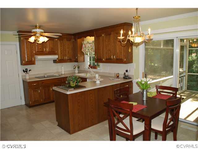 3908 Timber Ridge Place Midlothian, VA 23112 - Photo 3 of 12 a kitchen with a table chairs and microwave