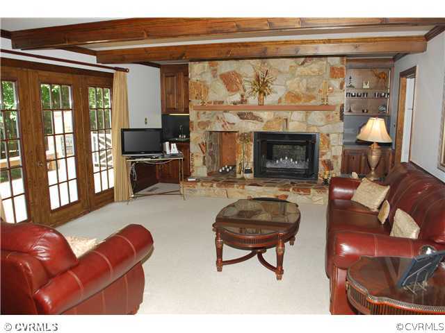 3908 Timber Ridge Place Midlothian, VA 23112 - Photo 5 of 12 a living room with furniture a fireplace and a flat screen tv