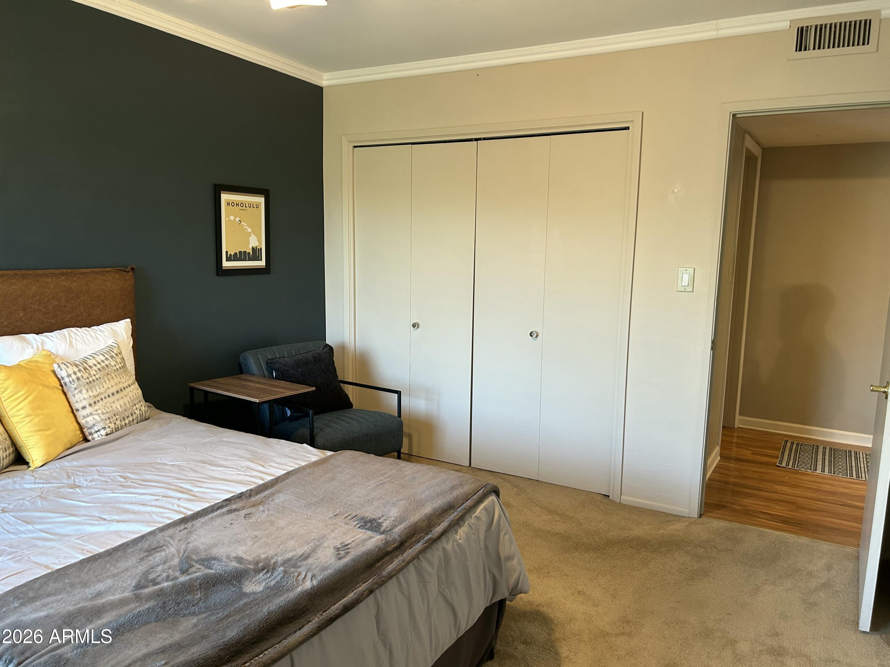 100 West Maryland Avenue, Unit O2 Phoenix, AZ 85013 - Photo 17 of 23 a bedroom with a bed and a cabinets