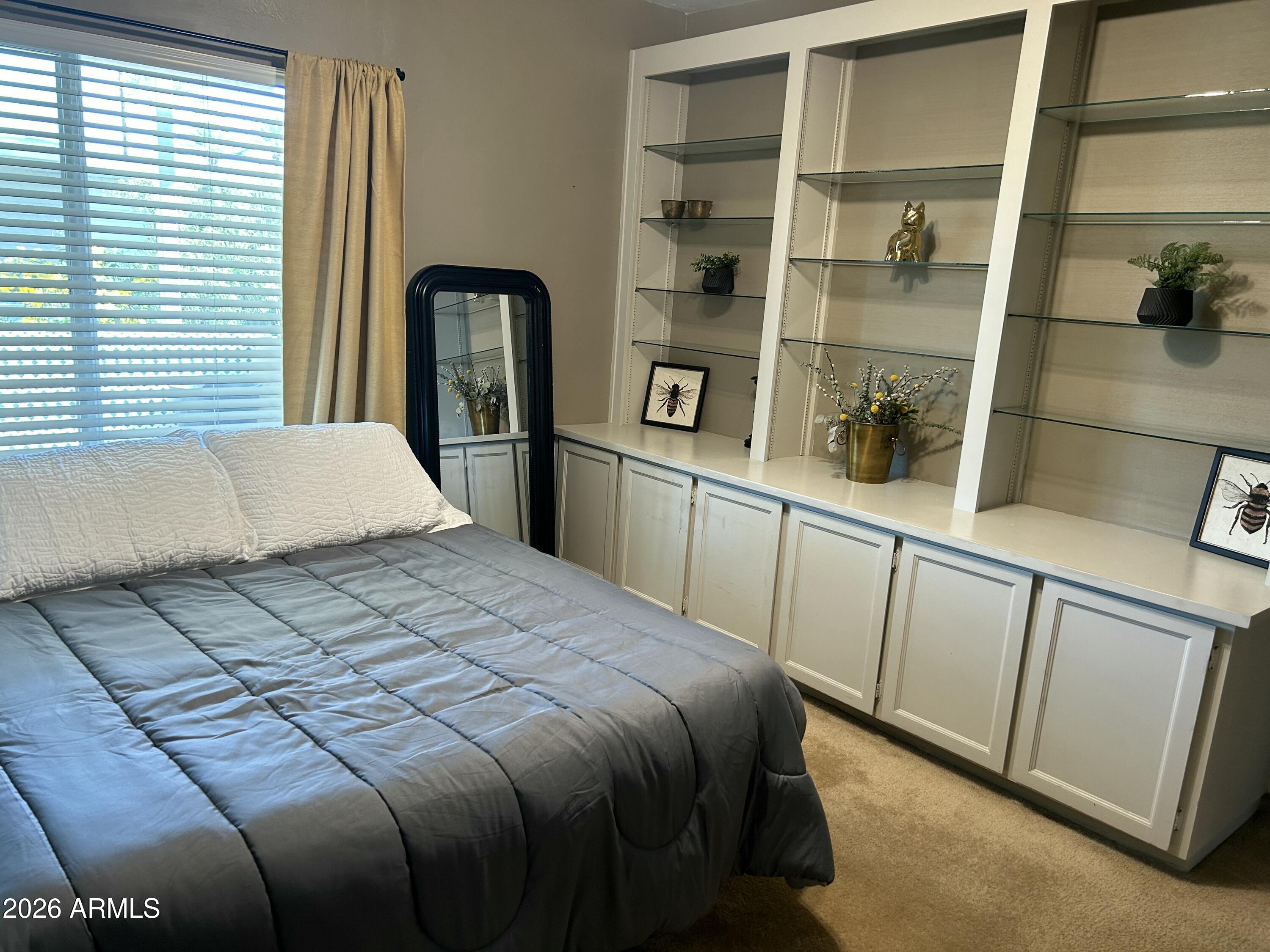 100 West Maryland Avenue, Unit O2 Phoenix, AZ 85013 - Photo 19 of 23 a bedroom with a bed and with cabinets