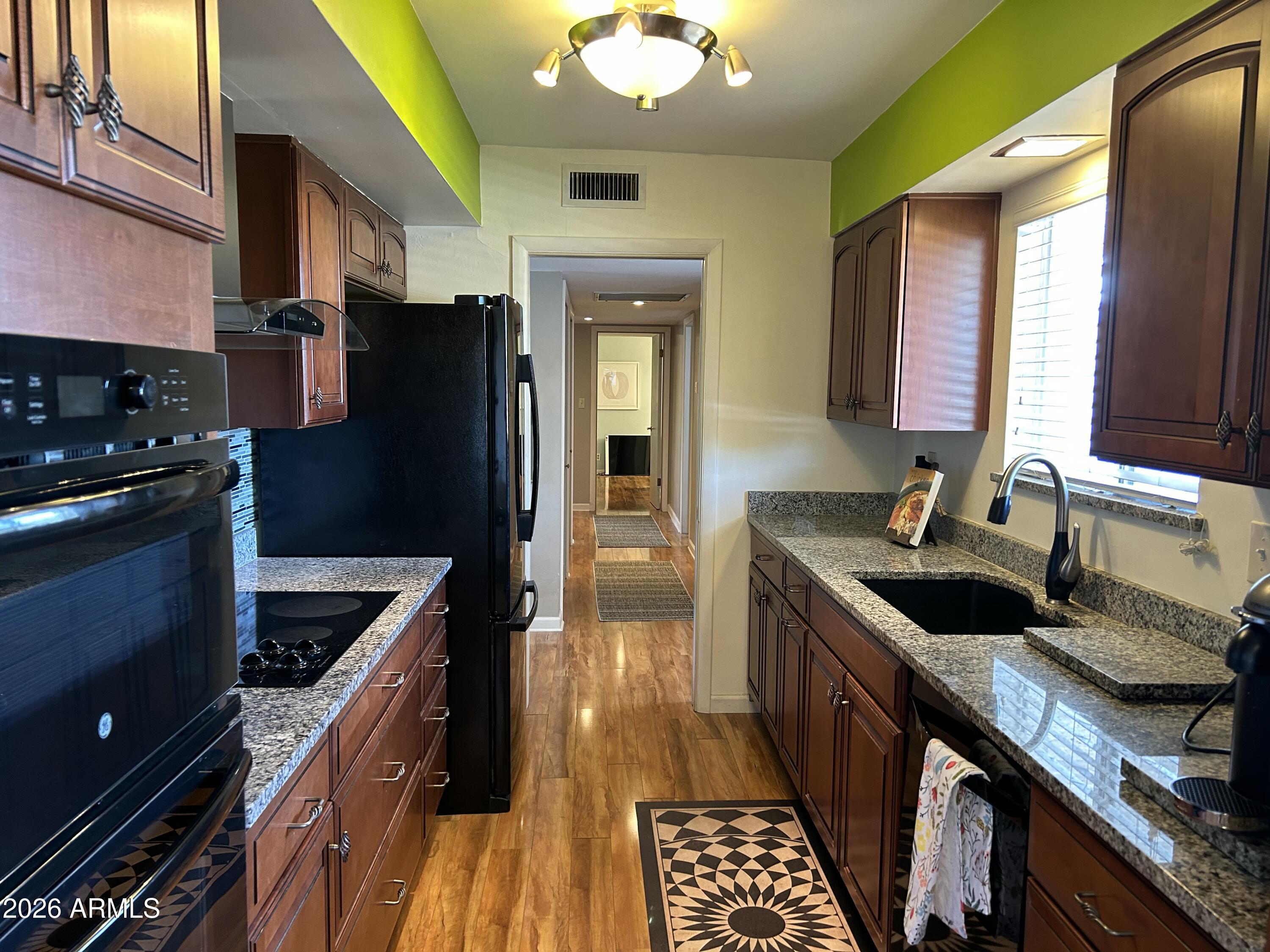 100 West Maryland Avenue, Unit O2 Phoenix, AZ 85013 - Photo 2 of 23 a kitchen with granite countertop stainless steel appliances a sink stove and refrigerator