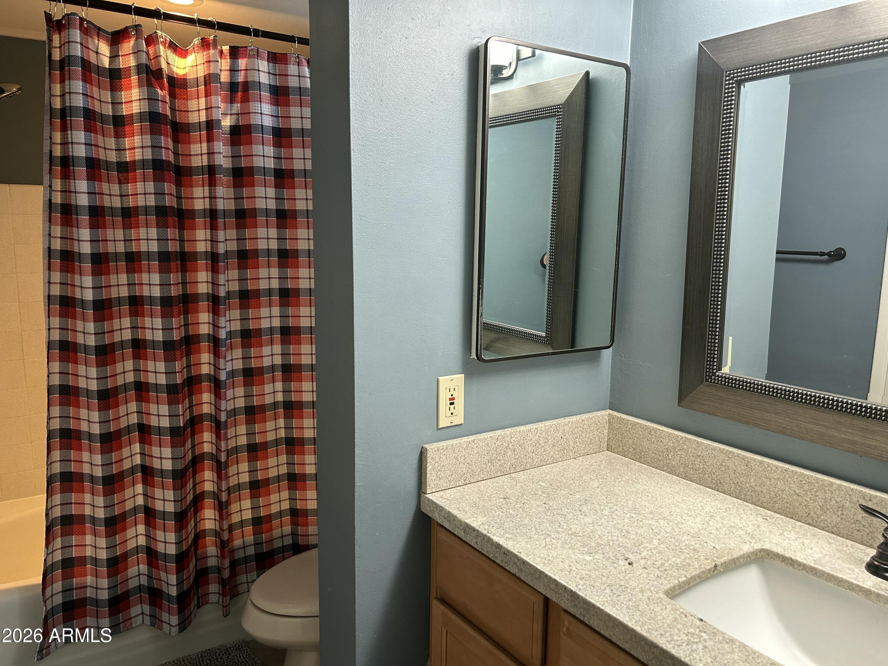 100 West Maryland Avenue, Unit O2 Phoenix, AZ 85013 - Photo 21 of 23 a bathroom with a granite countertop sink a toilet a mirror and shower