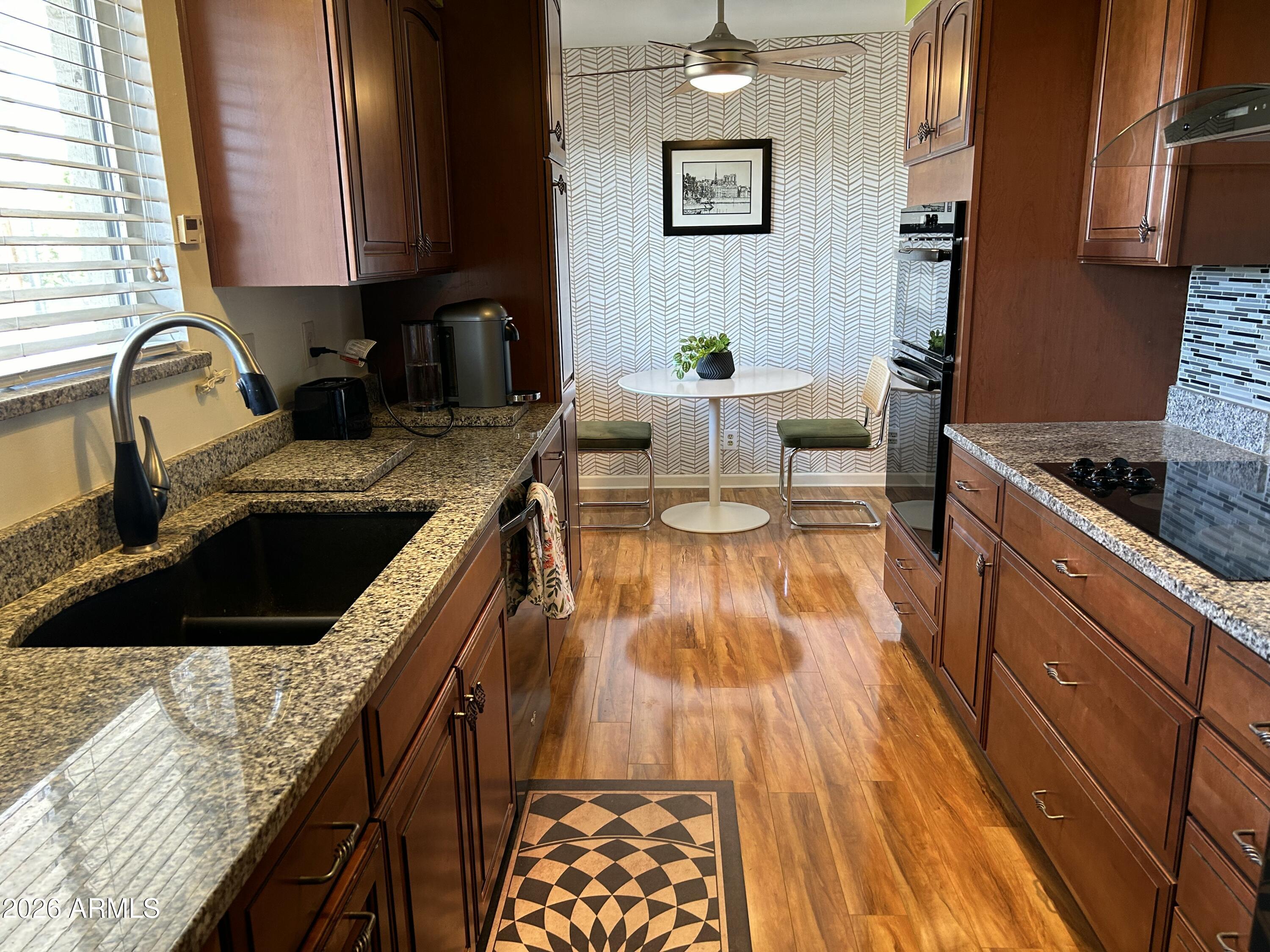 100 West Maryland Avenue, Unit O2 Phoenix, AZ 85013 - Photo 3 of 23 a kitchen with granite countertop lots of counter top space and wooden floor