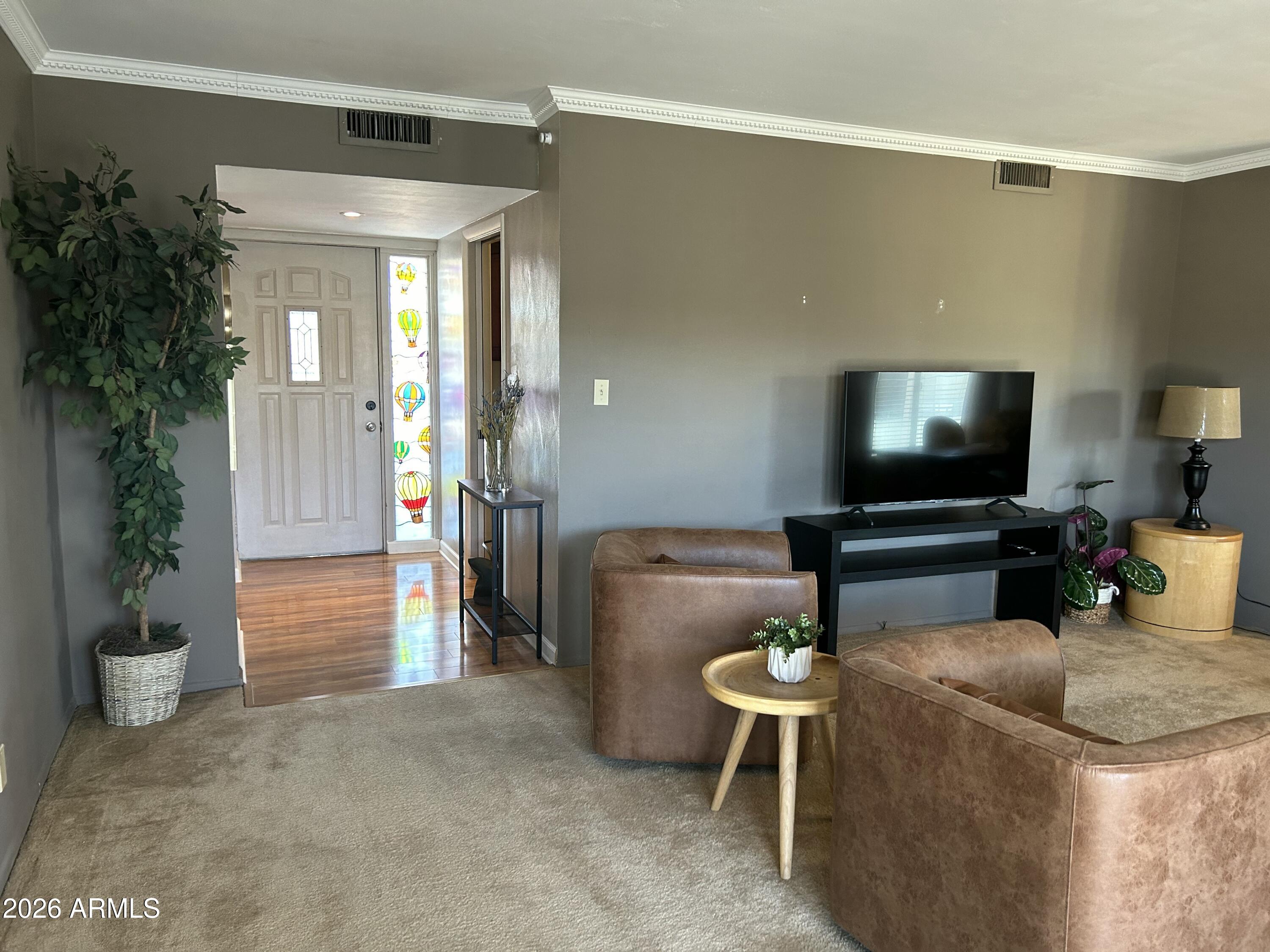 100 West Maryland Avenue, Unit O2 Phoenix, AZ 85013 - Photo 8 of 23 a living room with furniture and a flat screen tv