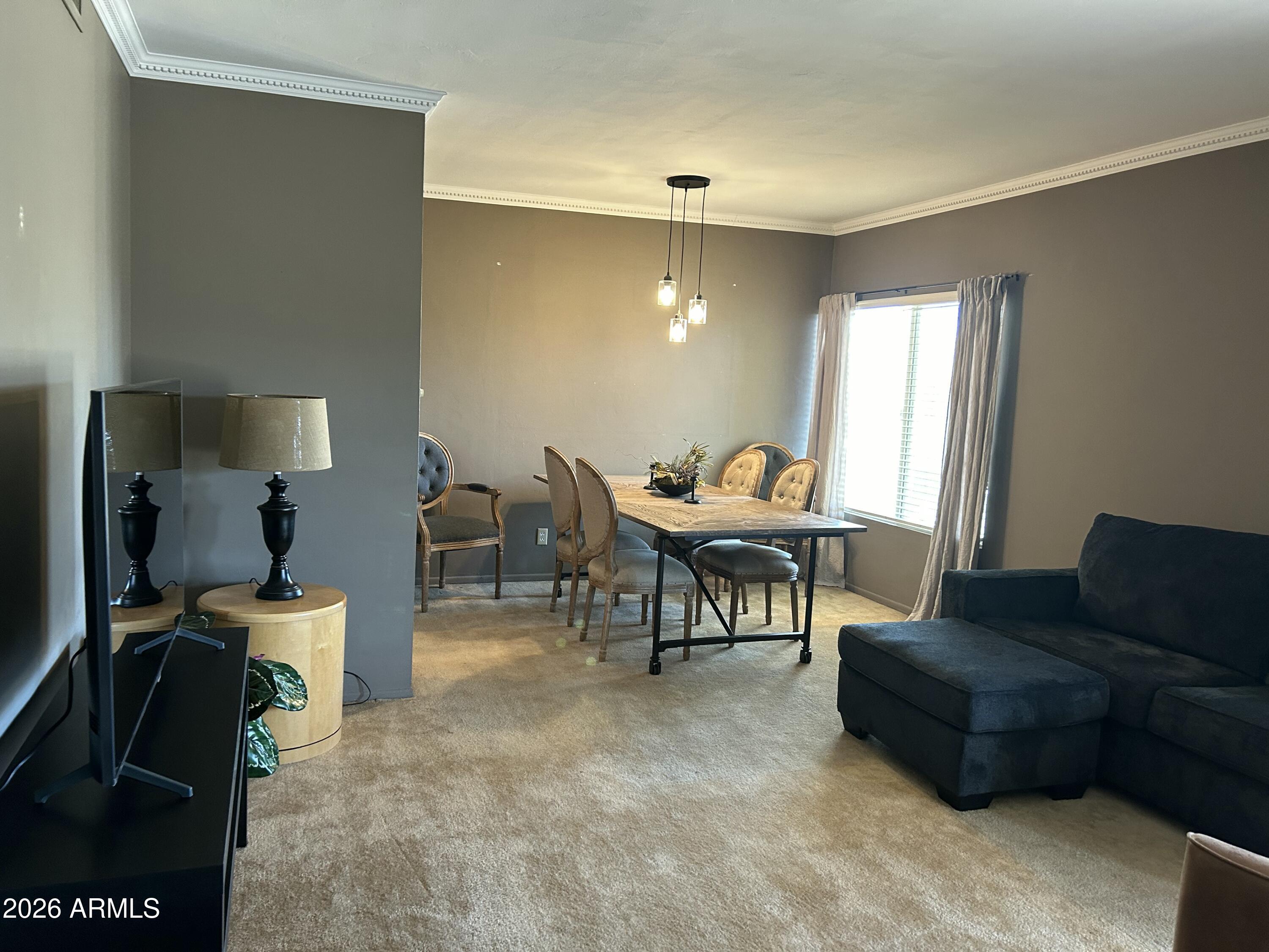 100 West Maryland Avenue, Unit O2 Phoenix, AZ 85013 - Photo 10 of 23 a living room with furniture and a flat screen tv