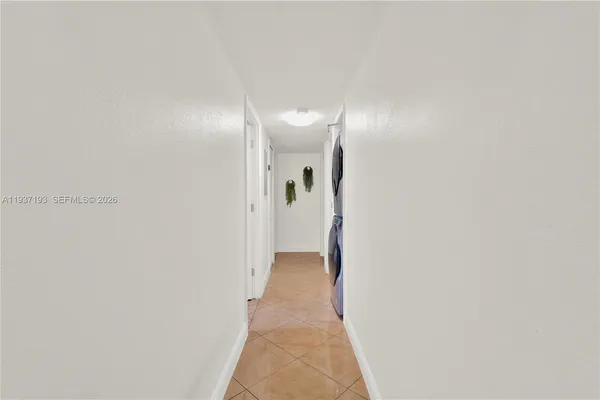 a view of a hallway with wooden shelves
