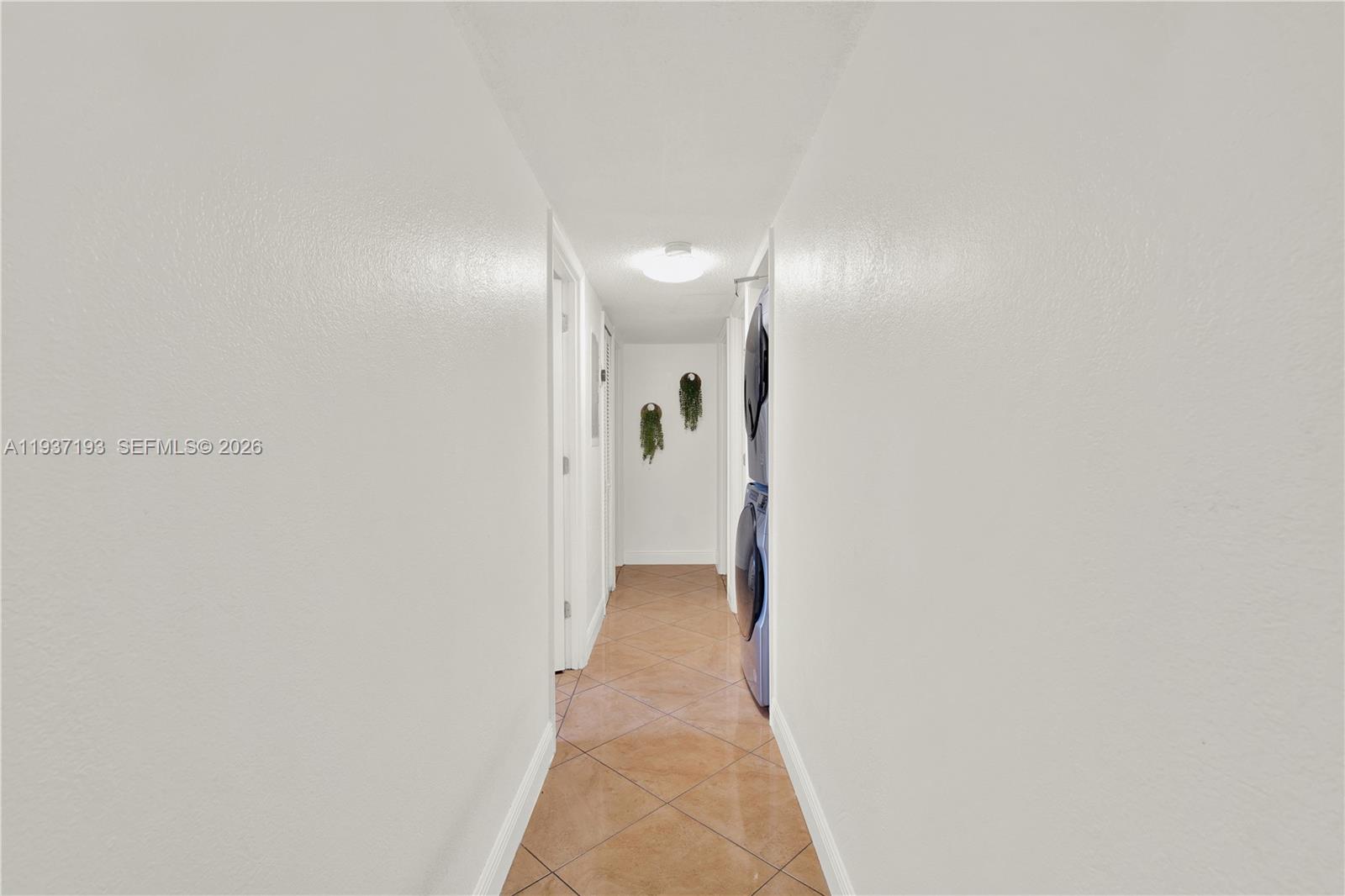 5665 West 20th Avenue, Unit 415 Hialeah, FL 33012 - Photo 12 of 23 a view of a hallway with wooden shelves