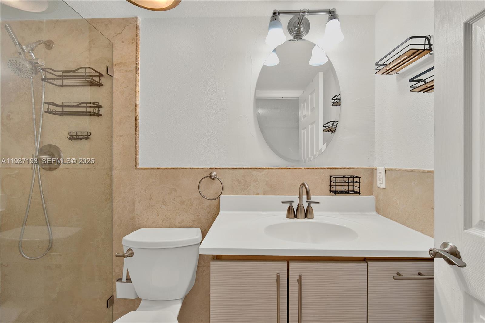 5665 West 20th Avenue, Unit 415 Hialeah, FL 33012 - Photo 13 of 23 a bathroom with a sink a toilet and shower