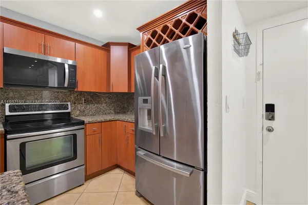 a metallic refrigerator freezer and a stove top oven