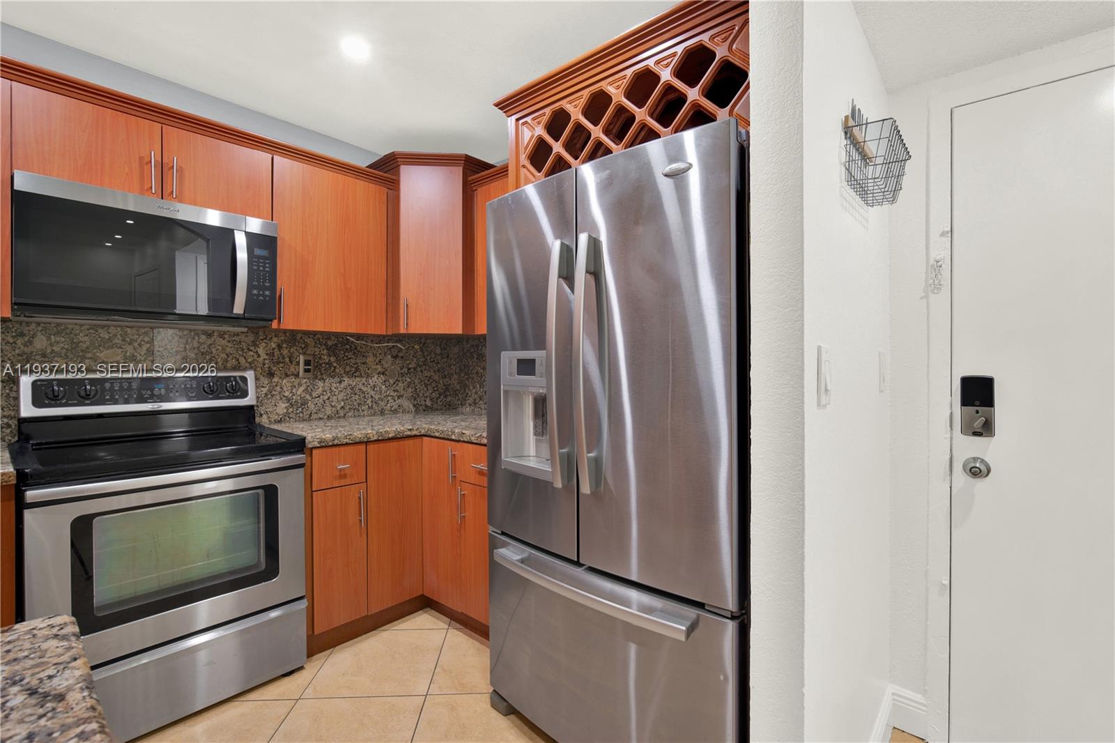 5665 West 20th Avenue, Unit 415 Hialeah, FL 33012 - Photo 5 of 23 a metallic refrigerator freezer and a stove top oven