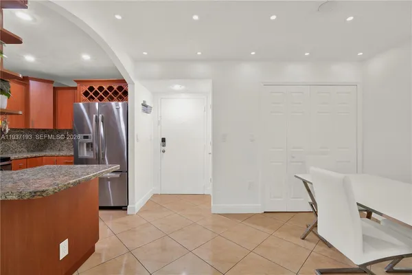 a kitchen with stainless steel appliances granite countertop a refrigerator and a sink