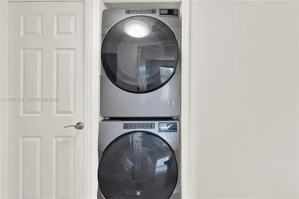 a close view of a utility room with dryer and washer