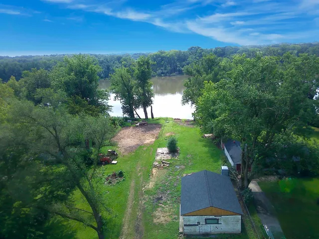 an aerial view of green landscape with trees houses and mountain view