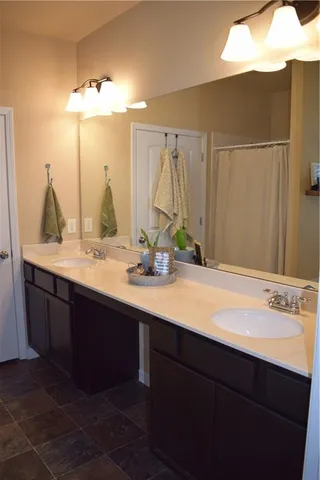 a bathroom with a sink vanity and a mirror