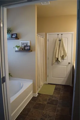 a bathroom with a tub and shower