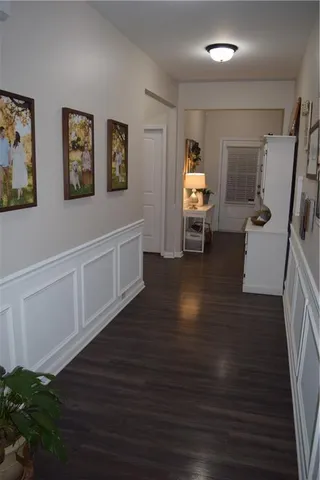 a hallway with wooden floor and furniture