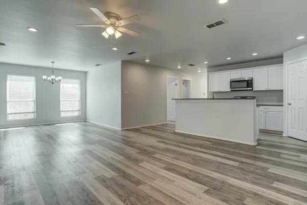 a view of a kitchen with a sink and a refrigerator