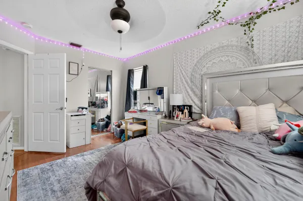 a bedroom with a bed and ceiling fan